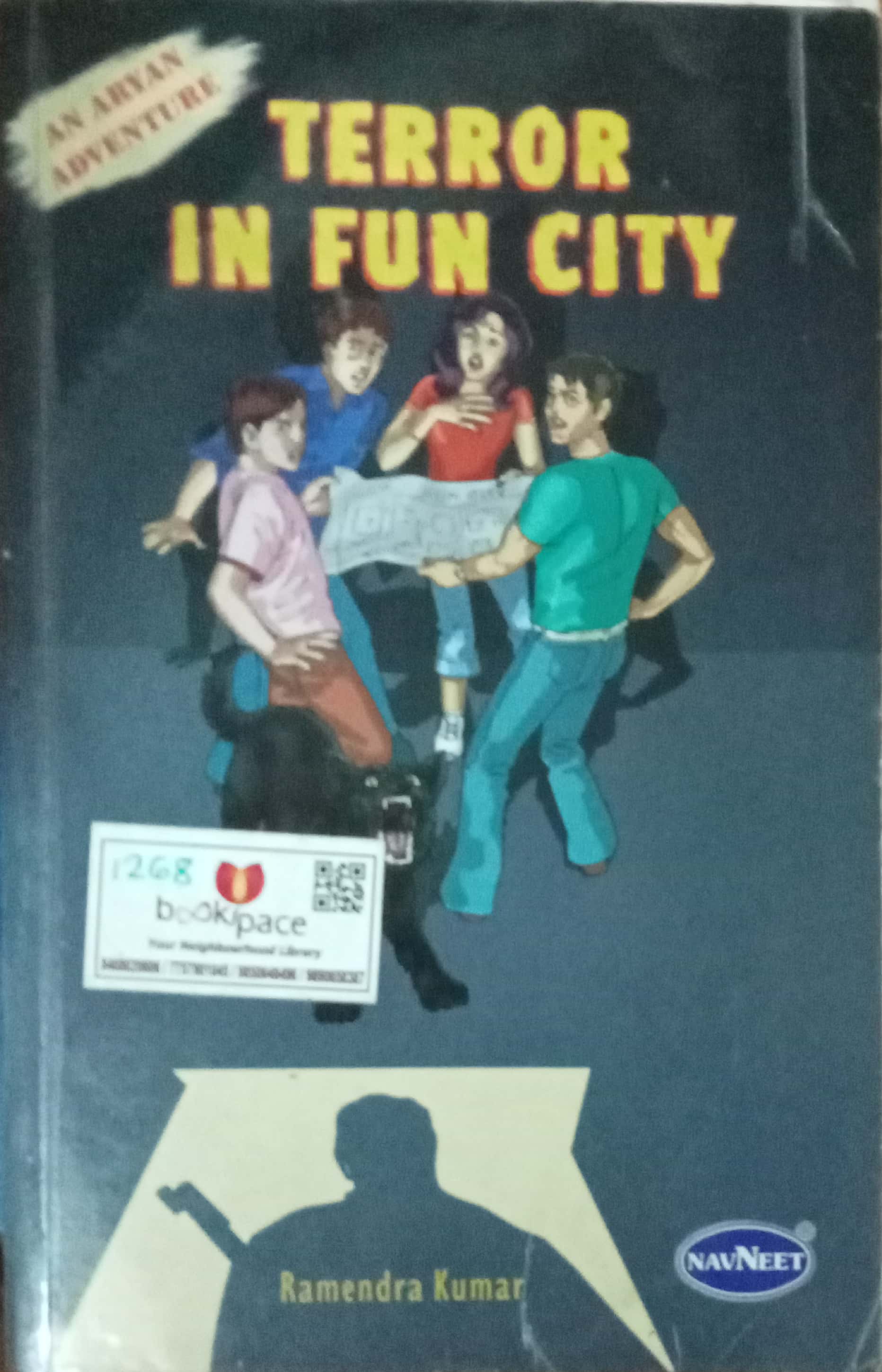Book cover for 'Terror in Fun City' by Ramendra Kumar, featuring an illustration of four children in a dark scene with a book on the ground. The cover has a dark blue-gray background, yellow title text, and a white Bookspace barcode sticker on the lower left.