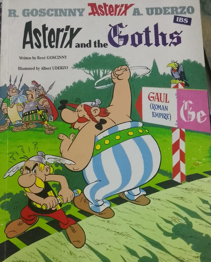 Book titled 'Asterix and the Goths' by R. Goscinny and A. Uderzo on a striped surface.
